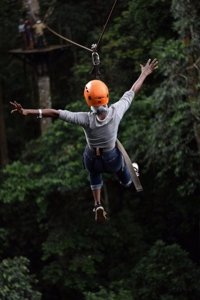 About Experience the thrill of ziplining through Uganda's lush forests with this adventurous capture.